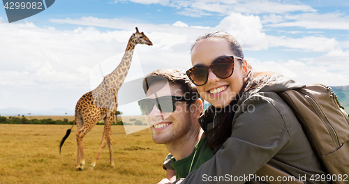 Image of happy couple with backpacks traveling in africa