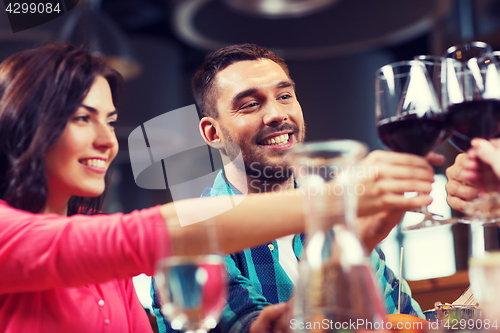 Image of friends clinking glasses of wine at restaurant