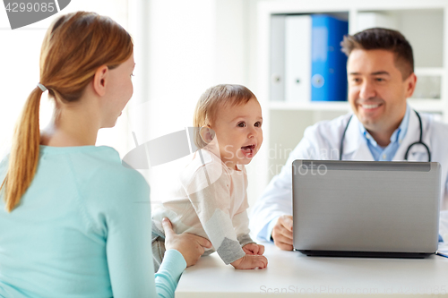 Image of woman with baby and doctor with laptop at clinic