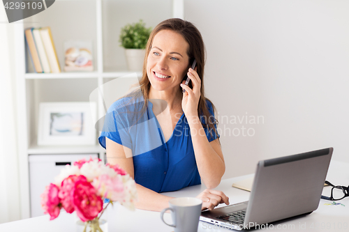 Image of woman calling on smartphone at office or home