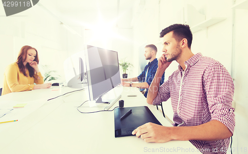 Image of man or designer with computer and tablet at office