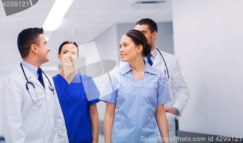 Image of happy group of medics or doctors at hospital