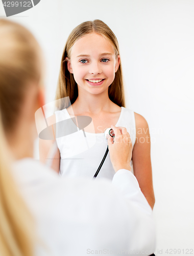 Image of doctor with stethoscope and girl at hospital