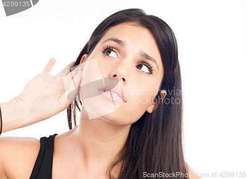 Image of Young woman trying to listen something