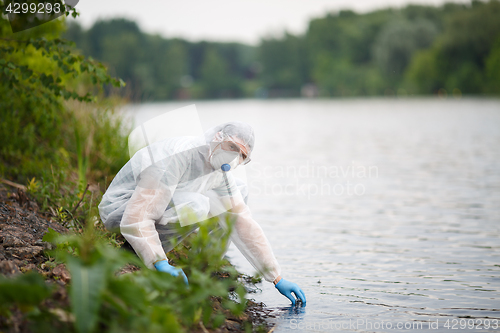 Image of Environmentalist takes sample of water