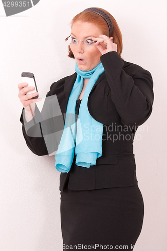 Image of Surprised Businesswoman with smartphone