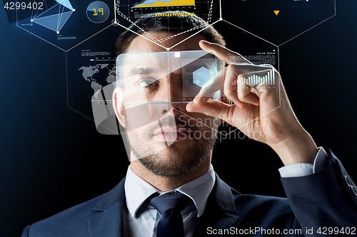 Image of businessman with smartphone and virtual holograms