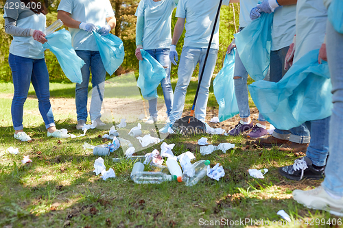 Image of volunteers with garbage bags cleaning park area