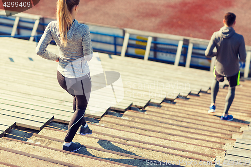 Image of close up of couple running downstairs on stadium