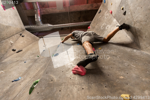 Image of young man exercising at indoor climbing gym