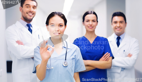 Image of group of medics at hospital showing ok hand sign