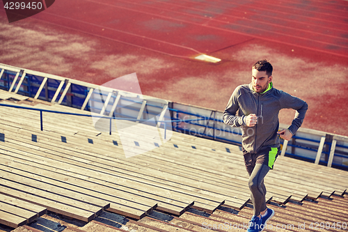 Image of young man running upstairs on stadium