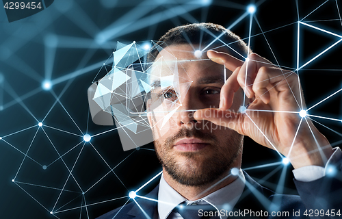 Image of businessman with transparent smartphone