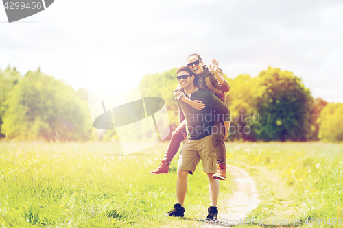 Image of happy couple with backpacks having fun outdoors