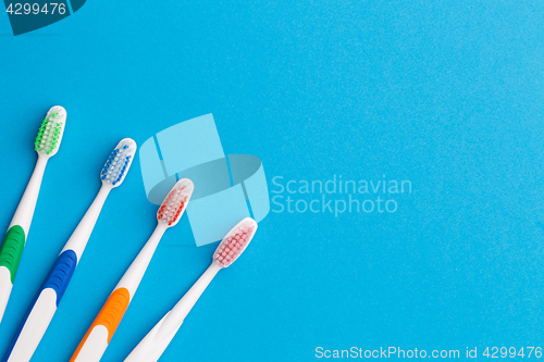 Image of Four toothbrushes nd, place for words