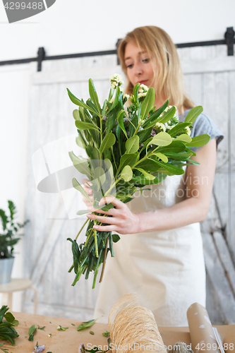 Image of Florist with bouquet at work