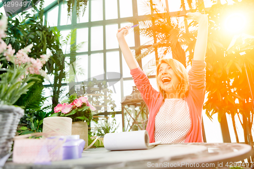 Image of Photo of happy flowers seller.