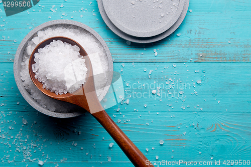 Image of sea salt in stone bowl and wooden spoon