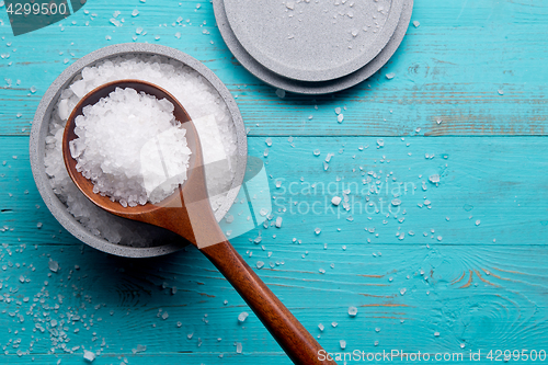 Image of sea salt in stone bowl and wooden spoon