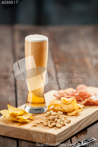 Image of Beer glass and potato chips, pistachios isolated on a white