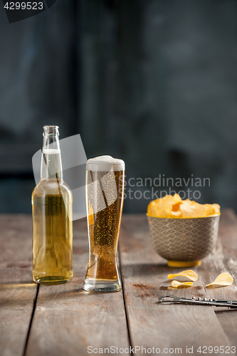 Image of Beer glass and potato chips, pistachios isolated on a white