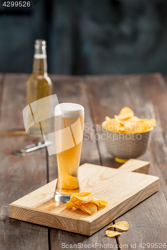 Image of Beer glass and potato chips, pistachios isolated on a white