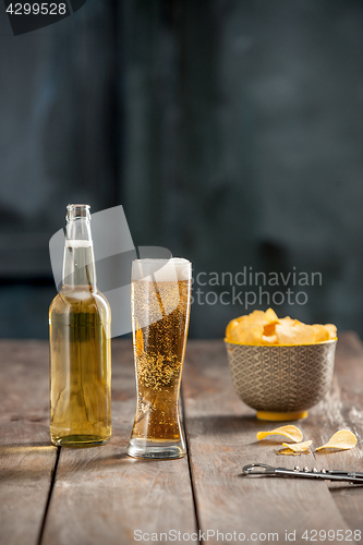 Image of Beer glass and potato chips, pistachios isolated on a white