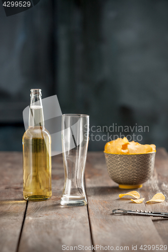 Image of Beer glass and potato chips, pistachios isolated on a white