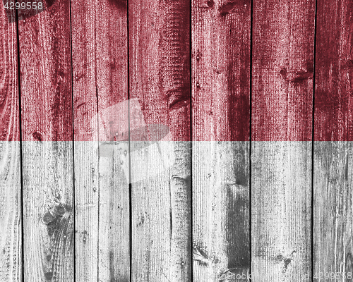 Image of Flag of the Monaco on weathered wood