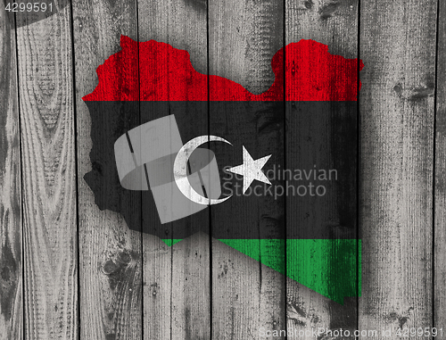 Image of Map and flag of Libya on weathered wood