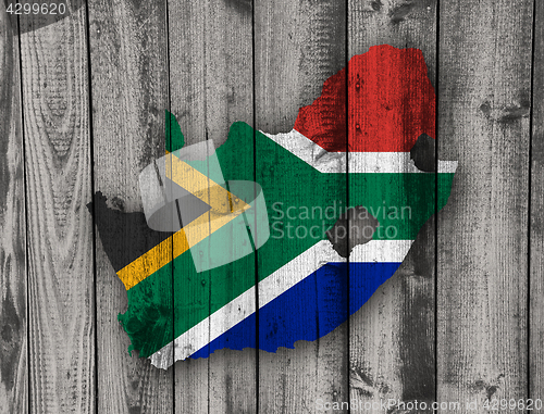 Image of Map and flag of South Africa on weathered wood