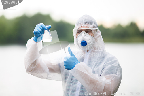 Image of Chemist with test-tube , blurred background