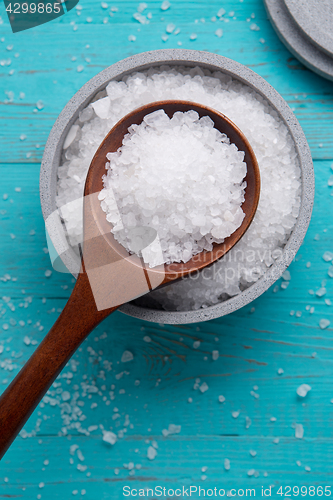 Image of sea salt in stone bowl and wooden spoon