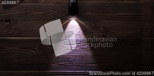 Image of Included flashlight on wooden background