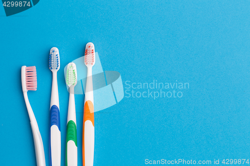 Image of Colorful toothbrushes, space for text
