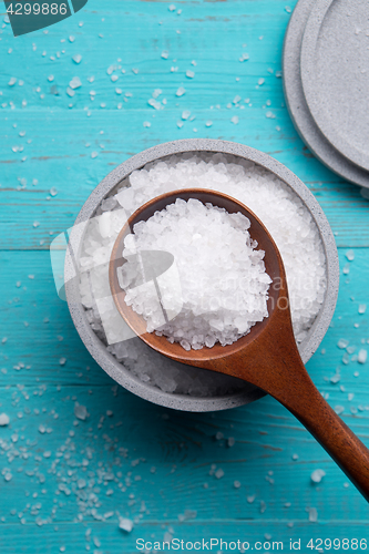 Image of sea salt in stone bowl and wooden spoon