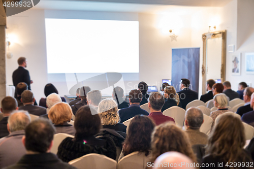 Image of Public speaker giving talk at Business Event.