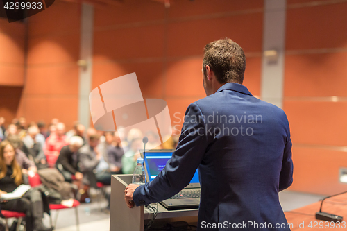 Image of Public speaker giving talk at Business Event.