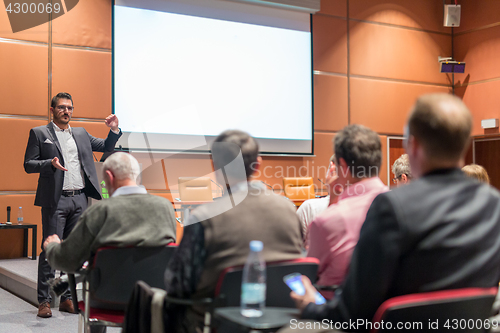 Image of Business speaker giving a talk at business conference event.