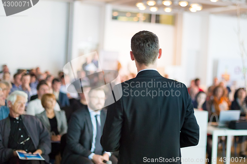 Image of Public speaker giving talk at Business Event.