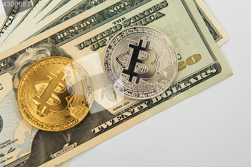 Image of Bitcoin coin with dollars