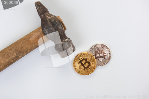 Image of Bitcoin coins with hammer