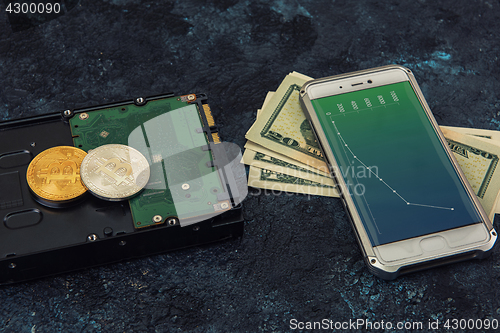Image of Bitcoin coin with HDD money and smartphone