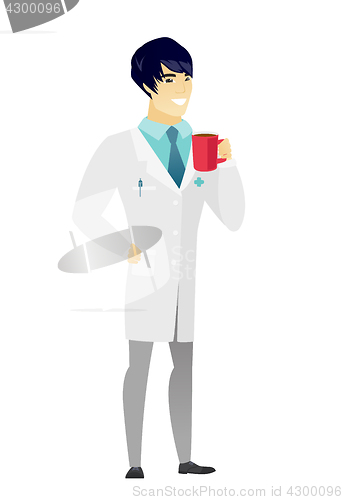 Image of Young asian doctor holding cup of coffee.