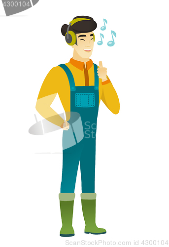 Image of Farmer listening to music in headphones.