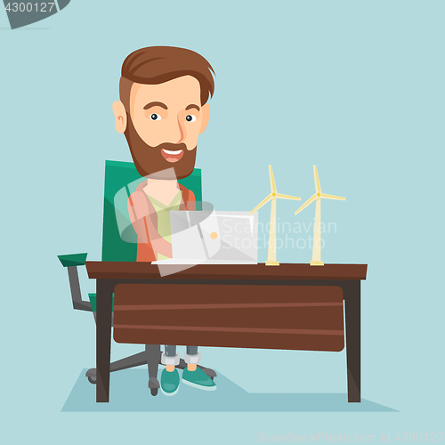 Image of Man working with model of wind turbines.