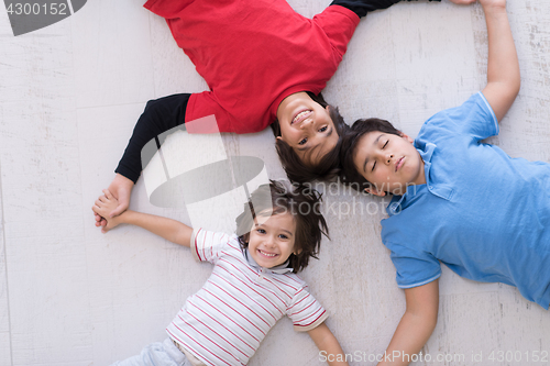 Image of young boys having fun on the floor