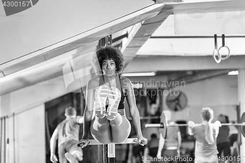 Image of black woman doing parallel bars Exercise