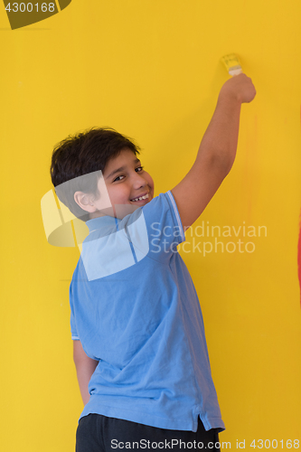 Image of Portrait of a happy young boy painter