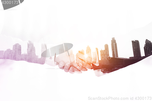 Image of Double exposure business man and woman handshake on  meeting